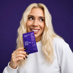 Woman holding a package of teeth whitening strips against a purple background