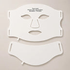 Flexible LED face and neck light therapy mask displayed on a soft stone-grey background in a premium skincare ecommerce setting.